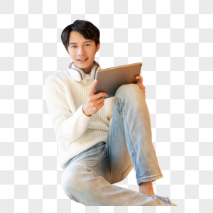 青年男性坐在地上使用平板电脑图片