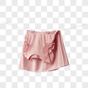 晾衣绳上晾晒着的粉色裙子图片