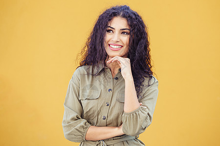 有思想的阿拉伯女人,留着城市背景的卷发年轻的阿拉伯女人,卷发户外图片