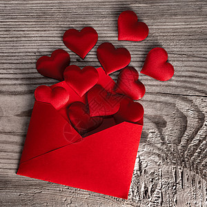 情人节情书,信封上的工艺红纸与红心堆木底情人节情书图片