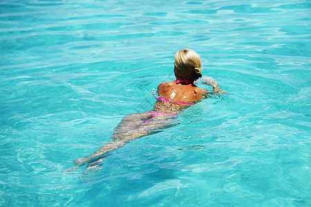 美丽的女人蓝色的海水或游泳池里游泳美丽的女人游泳图片