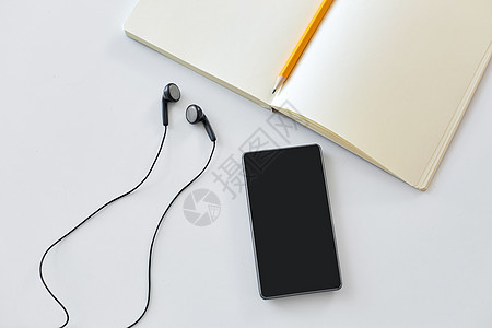 技术象耳机,智能手机笔记本与铅笔白色背景耳机,智能手机带铅笔的笔记本图片