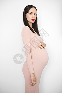 时尚的照片,优雅的怀孕黑发女人穿米色连衣裙美丽的怀孕爱关心图片