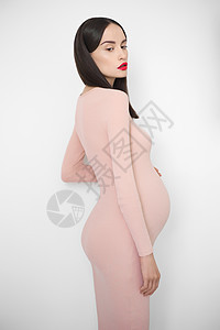 时尚的照片,优雅的怀孕黑发女人穿米色连衣裙美丽的怀孕爱关心图片