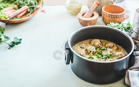 烹饪锅与荞麦球奶油酱站厨房桌子上与草药配料健康的家庭食品烹饪图片