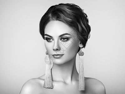 漂亮的女人戴着大耳环流苏珠宝完美的妆容优雅的发型时尚化妆箭头黑白照片图片