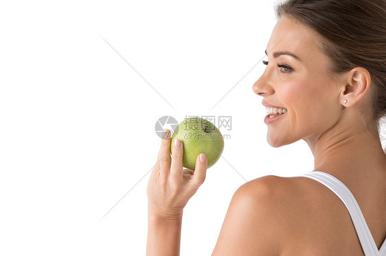 美丽的微笑,洁白有力的牙齿年轻女人的头肩膀带着雪白的牙齿微笑,着绿色的苹果,牙齿护理工作室隔离白色背景上着绿图片