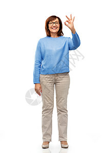 手势,视觉老人的微笑的老年女子眼镜上的肖像,白色背景上OK手标志快乐的老年女子戴着眼镜,出好的手势图片