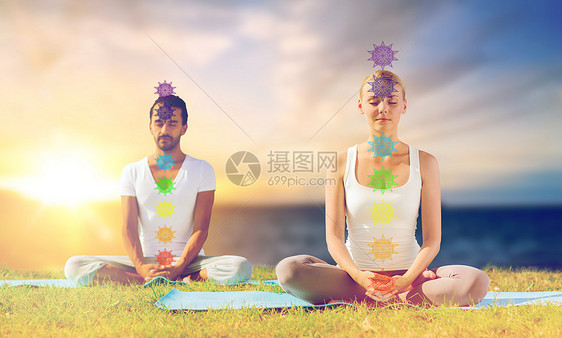 正念,灵户外瑜伽夫妇冥想莲花姿势与七个脉轮符号海洋阳光背景夫妇用莲花姿势七个脉轮瑜伽图片