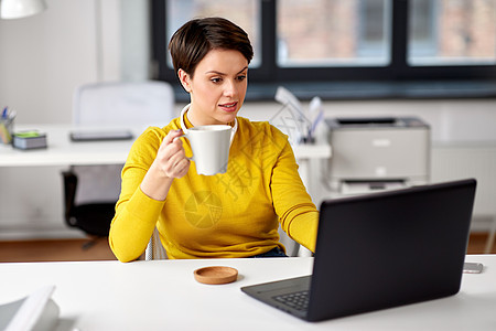 商业,休息人的女商人带着笔记本电脑办公室喝咖啡女商人办公室着笔记本电脑喝咖啡图片