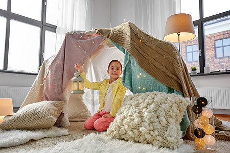 童潮湿的快乐的小女孩带灯笼孩子帐篷帐篷家里孩子们家里的帐篷里灯笼的小女孩图片