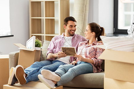 移动,人,维修房地产幸福的夫妇与相框纸板箱坐沙发上的新家幸福的夫妇带着箱子搬新家图片