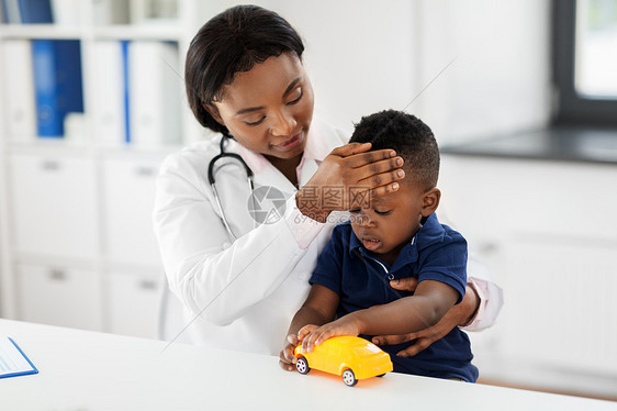 医学,保健,儿科人的快乐的非裔美国女医生儿科医生测量婴儿的温度手工诊所的医疗检查诊所测量婴儿体温的医生图片