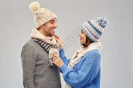 人们,诞节冬天的衣服幸福的夫妇针帽围巾灰色背景穿着冬天衣服的快乐夫妇图片
