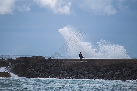 拉克鲁兹港渔夫站码头上钓鱼巨浪图片