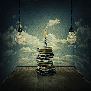 想法与个男孩站堆书上试图灯泡上,周围的混凝土墙壁与云质感思维的限制为了寻找知识图片