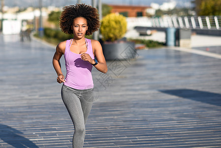 黑人女人,阿夫罗发型,城市道路上户外跑步轻女穿着运动服锻炼图片