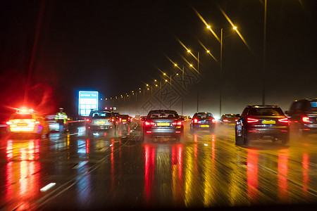 运动模糊的照片,夜间雨中与汽车英国高速公路上的交通图片