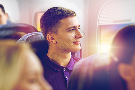 运输,旅游航空飞行快乐的轻人乘飞机舷窗背景下旅行快乐的轻人乘飞机旅行快乐的轻人乘飞机旅行图片