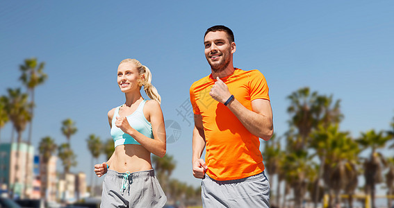 健身,运动健康的生活方式微笑夫妇与心率手表运行跑步夫妇背景图片