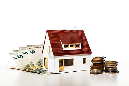 白色背景上的硬币上的钱屋公用事业付款补贴的钱的房子图片