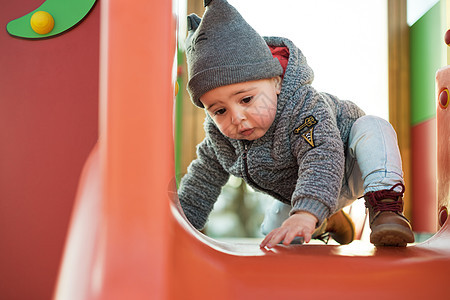 蹒跚学步的孩子玩得开心小男孩蹒跚学步的公园里玩得很开心图片