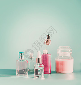 套现代部护肤化妆品蓝色背景产品瓶与滴管吸管,雾喷雾,血清保湿璃瓶前的风景品牌模型图片