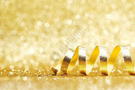 金色卷曲丝带装饰闪光的背景特写图片