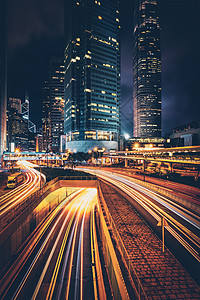 香港夜间的街道交通写字楼摩天大楼高速公路上繁忙的交通,车辆模糊,小径轻盈中国香港香港夜间的街道交通背景图片