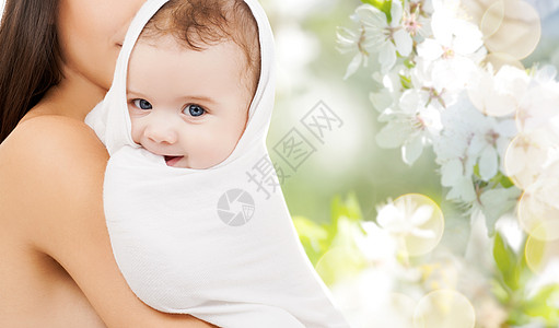 家庭母亲的亲密的母亲与小婴儿包浴巾樱花背景用浴巾把孩子关来图片