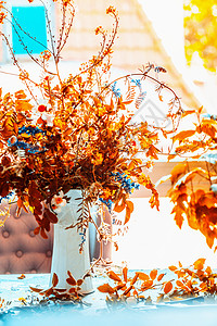 秋天的花蓝色的桌子上,阳光明媚舒适的家居室内装饰坠落静物,正视野图片