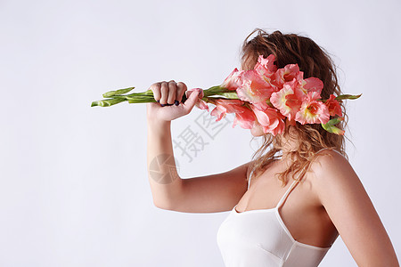 个女人用菖蒲花遮住她的脸生活方式图片