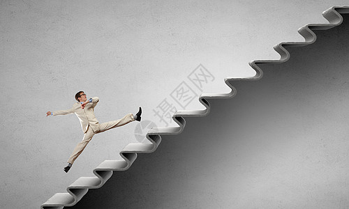 轻的商人走楼梯上,代表着成功的上职业阶梯图片