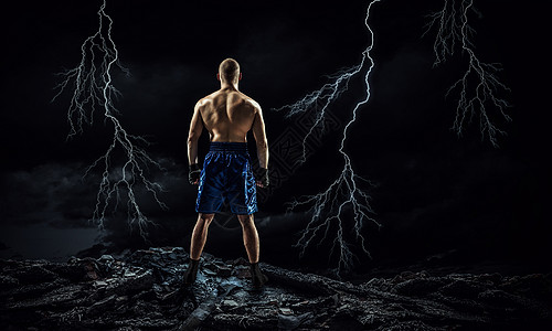 箱式战斗机户外训练黑暗背景下的强壮拳击手展示了力量耐力图片