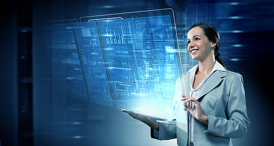 用现代技术的妇女高科技蓝色背景的平板电脑的女商人图片