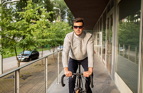 生活方式,交通人们的轻人戴太阳镜骑自行车城市街道图片