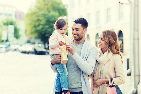 销售,消费主义人们的幸福的家庭与孩子购物袋城市图片