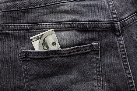 金融,衣服货币美元钱后口袋的牛仔牛仔裤背景图片