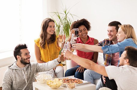 友谊,假期,快餐庆祝快乐的朋友家里举行聚会喝饮料朋友们家里举行聚会喝饮料图片