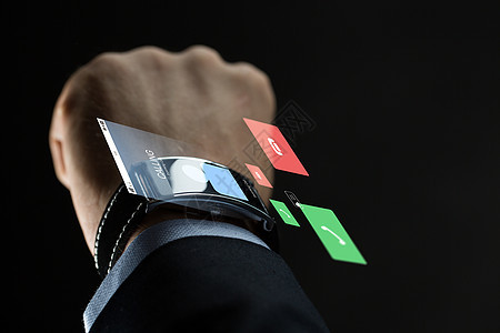 商业,人,通信技术密切的商人手与智能手表来电虚拟投影黑色背景用智能手表商人的手图片