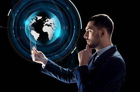 商业,增强现实未来的技术商人适合与透明平板电脑PC计算机虚拟地球全息图黑色背景下工作拥平板电脑虚拟地球仪的商图片