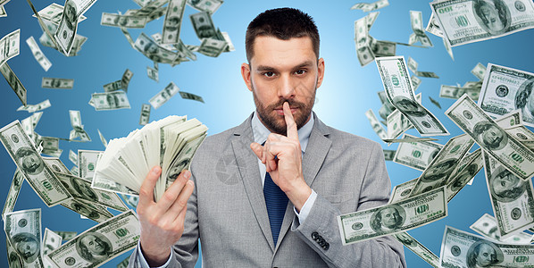 商业,人财务商人与捆绑美元现金蓝色背景美元钱的商人背景图片
