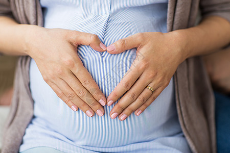 怀孕,爱人的密切孕妇手心肚子上靠近孕妇腹部心脏背景图片