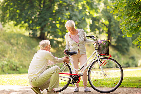 积极的老,人生活方式的快乐的老夫妇与固定自行车夏季城市公园快乐的老夫妇夏季公园骑自行车图片