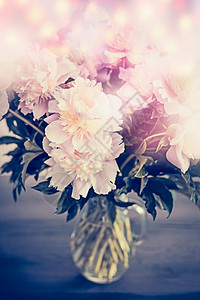 美丽的粉红色牡丹璃花瓶桌子上与博凯照明浪漫的花,正景色图片