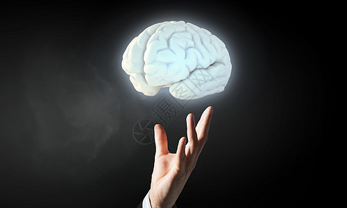 男手中的大脑商人把人脑的形象握手心里背景图片