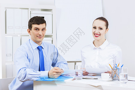 办公室里的商人女商人坐桌子前交谈合伙工作背景图片
