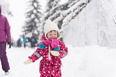 快乐微笑的小女孩户外玩得开心,下雪的冬日玩耍的肖像图片
