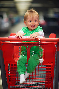 快乐地拍打婴儿杂货店超市购物车高清图片