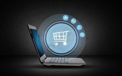 技术,商业,电子商务销售开放式笔记本电脑与购物车图标投影深灰色背景图片